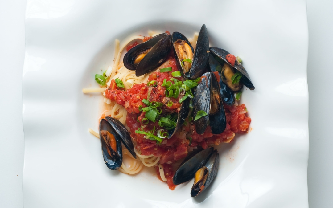 Tomato Basil Mussels Served Over Pasta