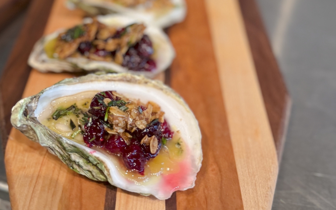 Baked Oysters with Cranberry Lager Sauce, Spiced Oat Crumble, and Roasted Garlic Rosemary Butter