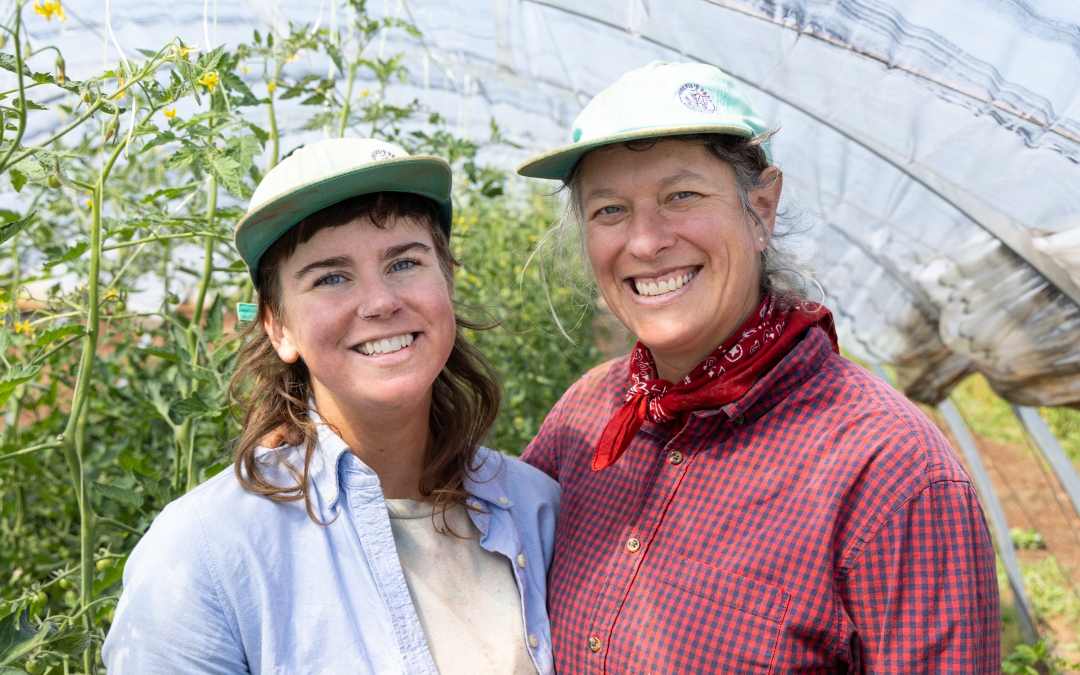Headshot of Lauren and Soleil with greenhouse in background